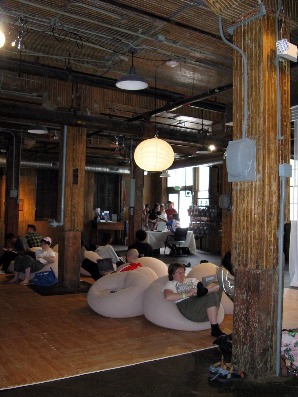 A First Flush gathering, participants at rest in a converted industrial space